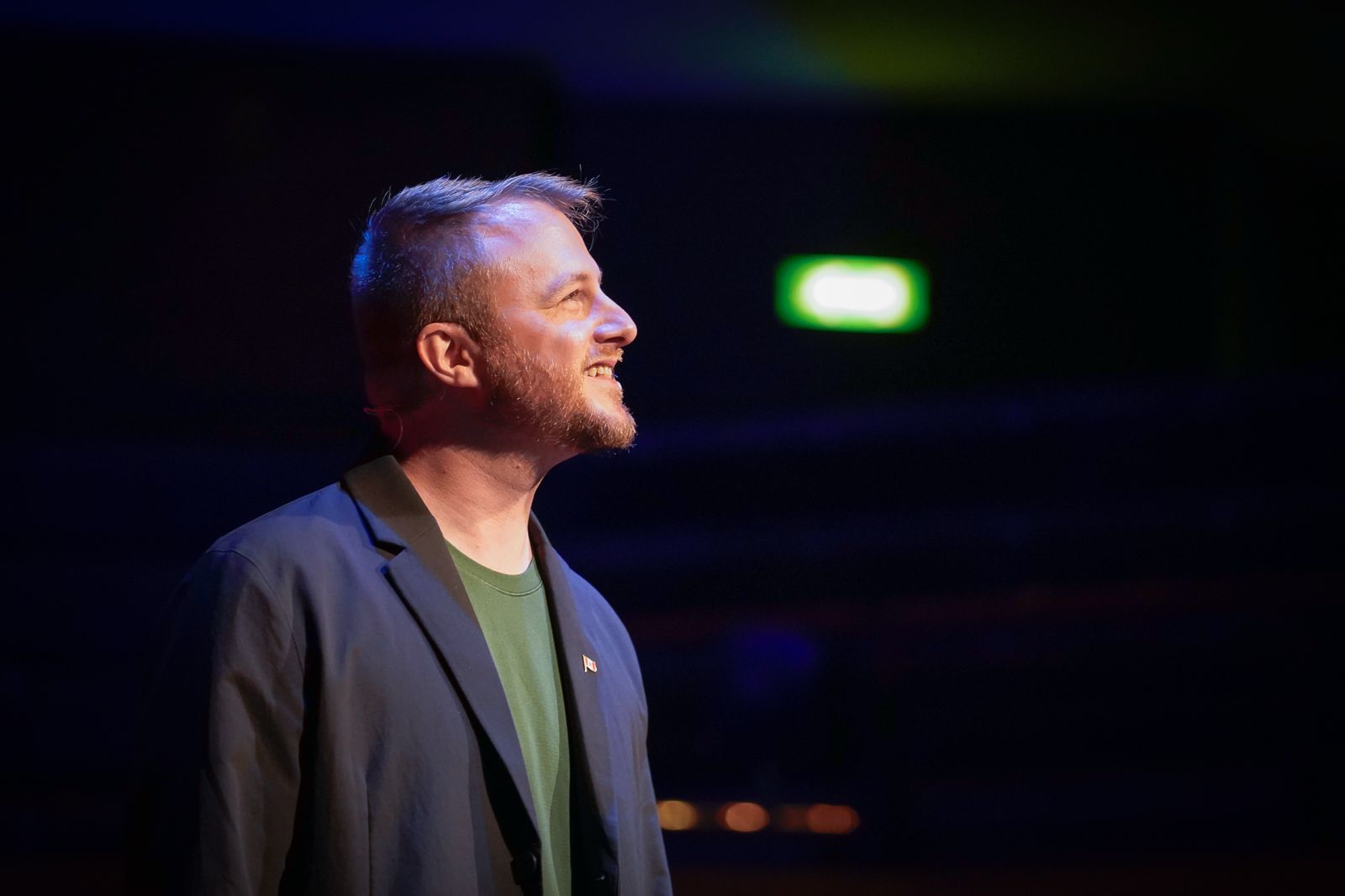 Chris Bailey on stage under blue lighting